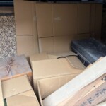茨木市で買取した茶道具や掛軸など。桐箱に箱書きのある品や掛軸の箱が並ぶ様子。本とあわせてお引き取り