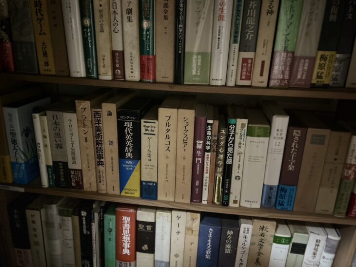 梅原猛『隠された十字架』や筑摩書房の世界古典文学全集、聖書思想事典などが並ぶ書棚